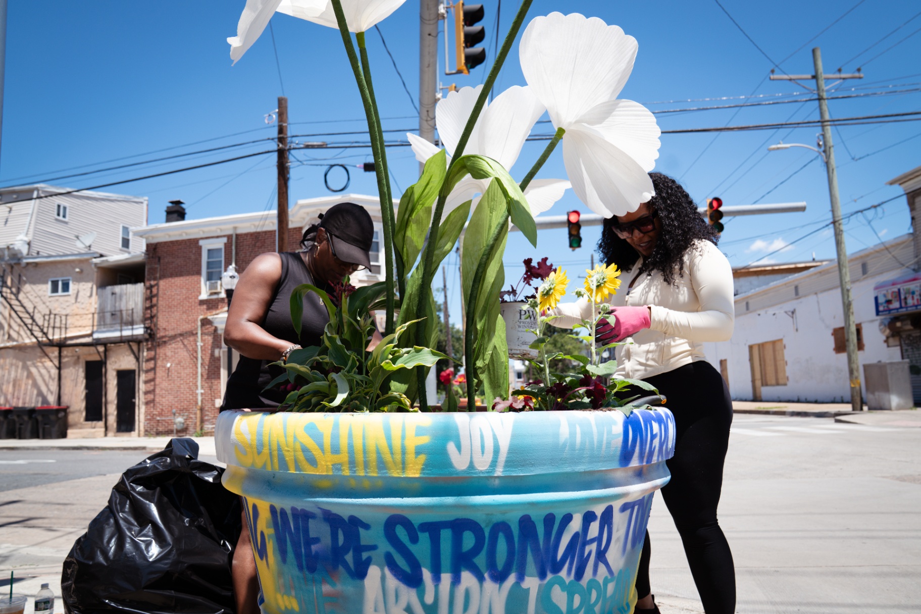 Neighbors planting together at the crosswalk